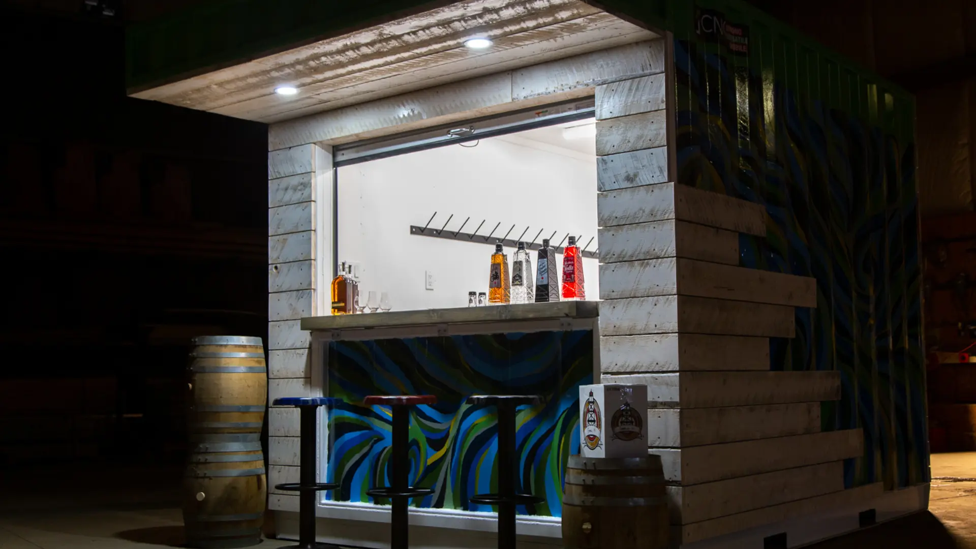 Square container repurposed as a bar with barstools