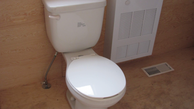 Close up of toilet and heater inside the container
