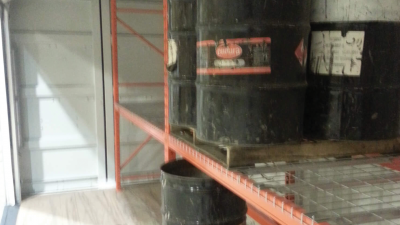 Close up of oil barrels on shelf inside of container