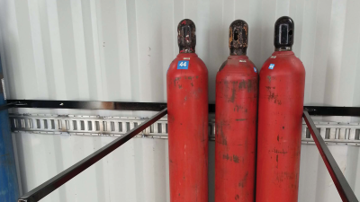 Three red pressurized cylinders