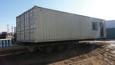 Container resting on trailer being pulled to be secured