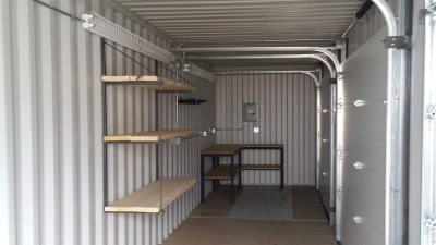 Inside of container with empty wooden shelving inside