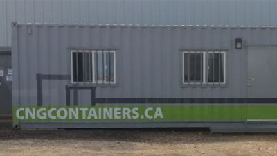 Half of the exterior of an office container highlighting the website on container