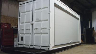 Side photo of white container with large bay door
