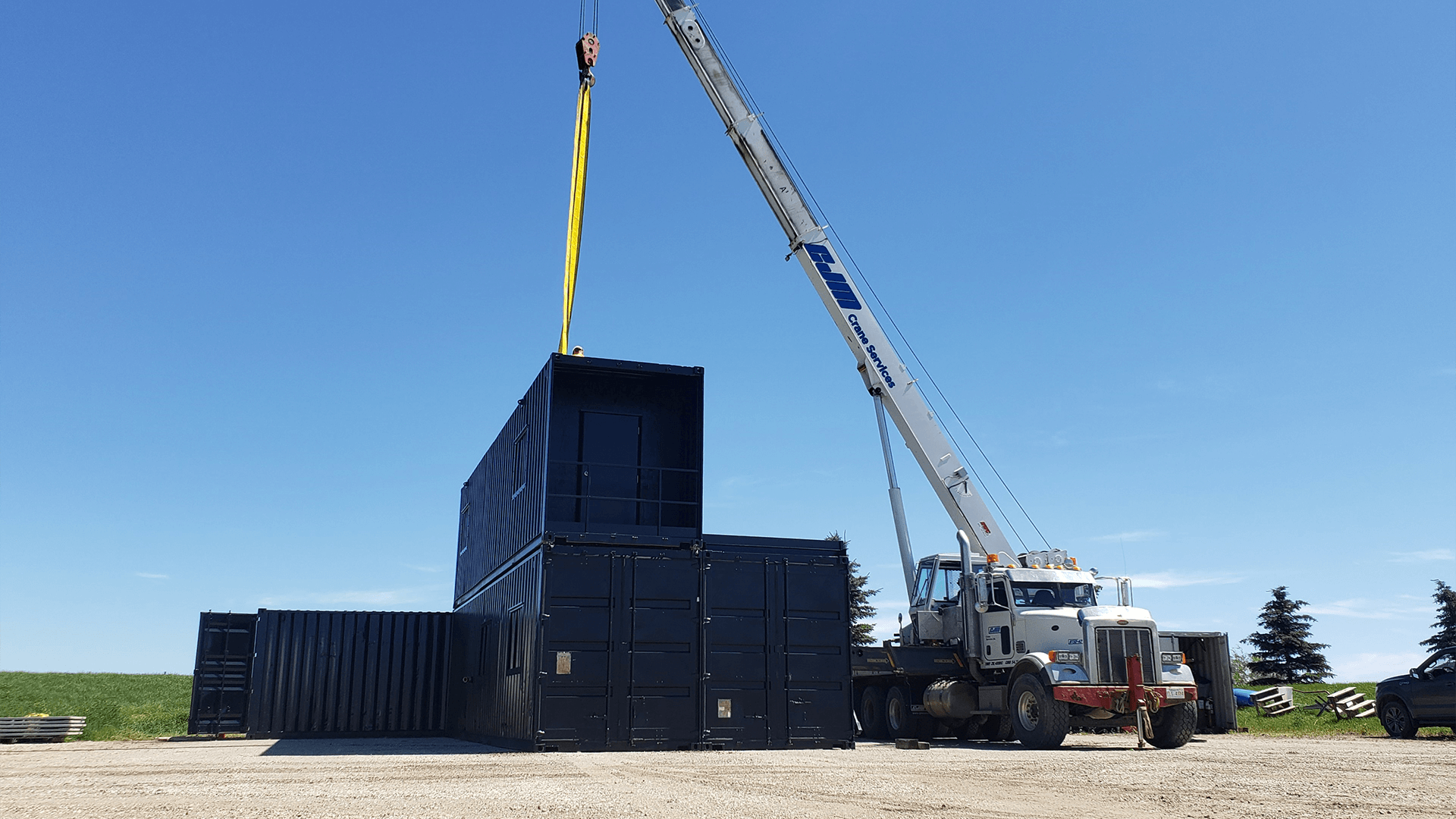 Crane moving container on top of other containers