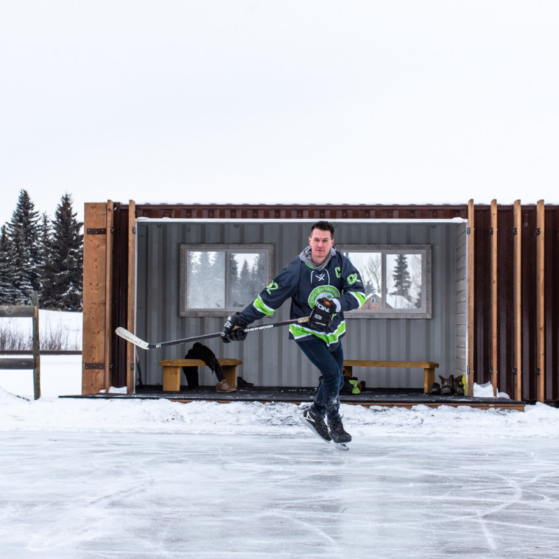 Ice hockey skater skating in front of skate shack container