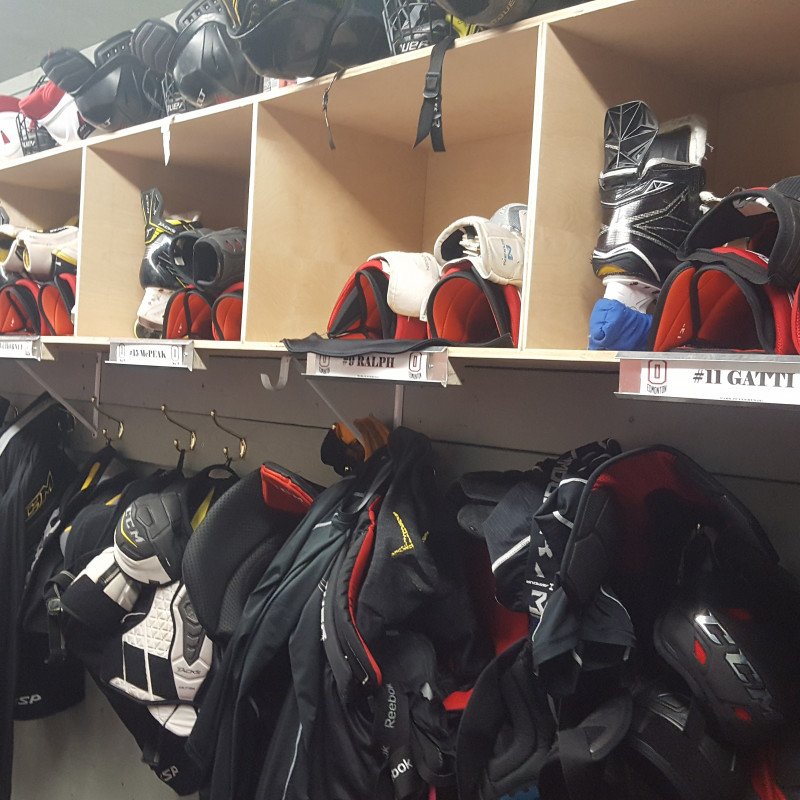 Hockey equipment on hangers and inside cubbies
