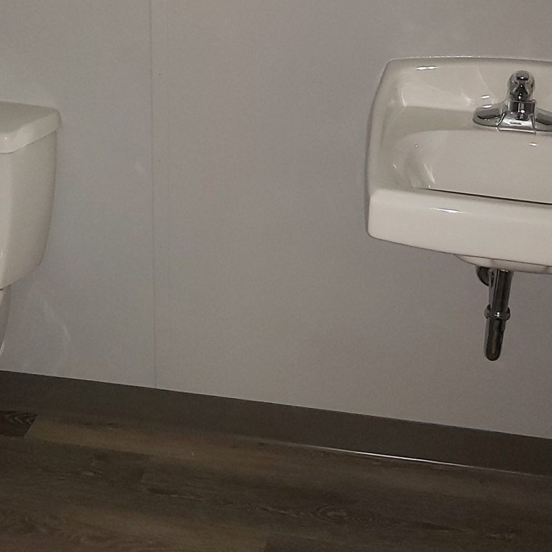 Bathroom sink and toilet inside of the container