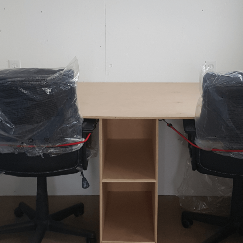 Desks and desk chairs inside office container