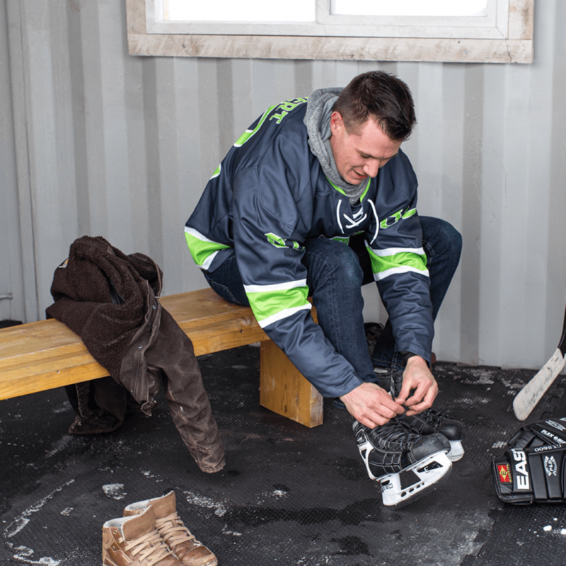 CNG owner tying skates inside of skate shack container
