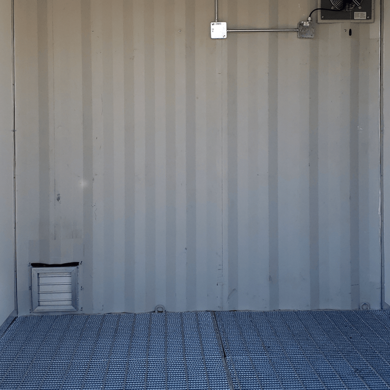 Inside one section of container with metal graded flooring