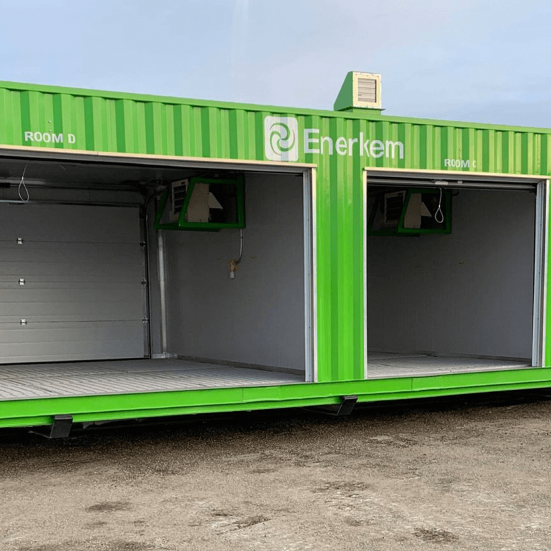 Green container with three open garage style containers