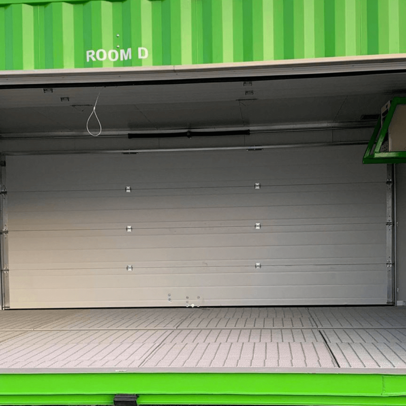 Large open garage door on container