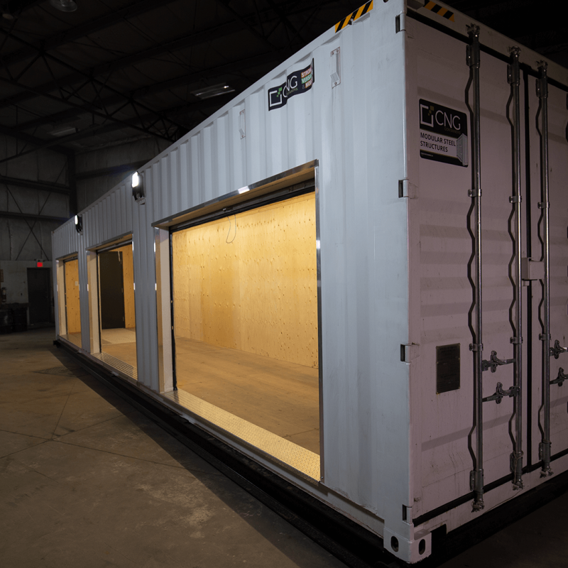 Large white container with three open bay style doors